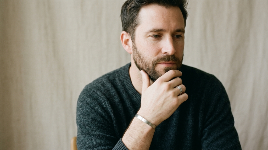 Close-up portrait of a thoughtful man in his 30s-40s wearing